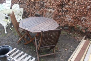 A varnished hardwood garden table and three foldin