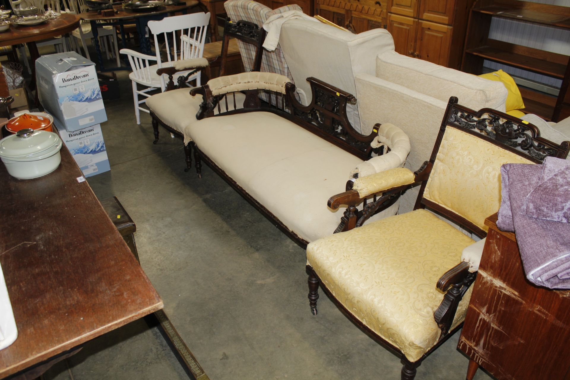 An Edwardian carved mahogany settee and two armcha