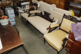 An Edwardian carved mahogany settee and two armcha