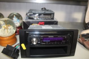 A JVC car stereo and a Kenwood car stereo