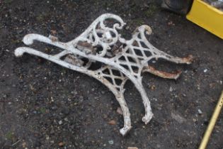 A pair of ornate white painted cast iron bench end