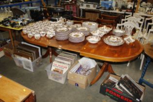 A reproduction yew wood twin pedestal dining table