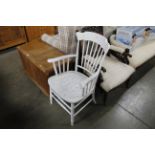 A white painted spindle back elbow chair