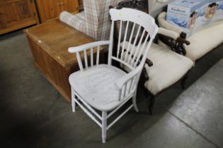 A white painted spindle back elbow chair