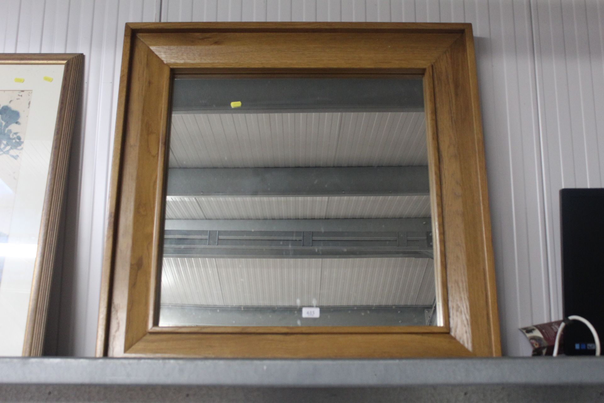 A modern light oak framed mirror