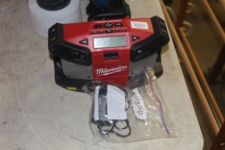 A Milwaukee C12JSR portable radio with charger