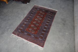 An approx. 5'7" x 3'2" patterned rug AF