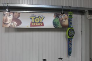 A Toy Story advertising picture and wall clock in