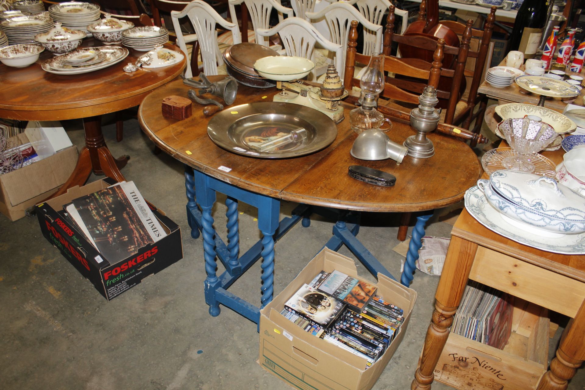 An oak gate leg table raised on barley twist suppo