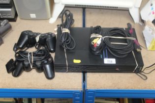 A Sony PlayStation II with two controllers