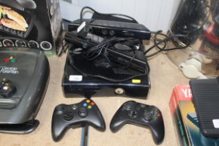 An X-Box 360 with two controllers