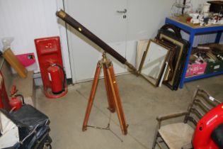 A brass and leather coloured telescope on tripod s