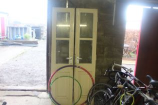 A pair of cream painted half glazed doors