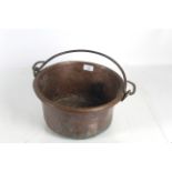 A copper jam pan with metal swing handle