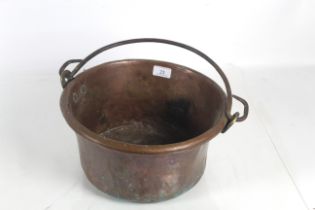 A copper jam pan with metal swing handle