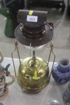 A Tilley storm lantern with brass oil vessel