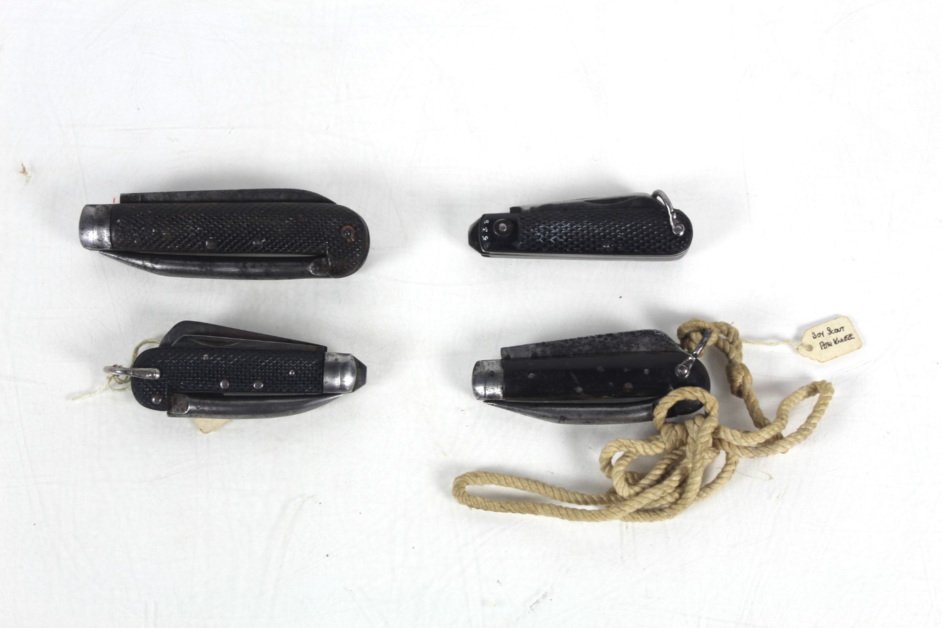 Four various black handled folding pen knives