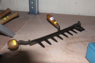 A vintage hand held hedge cutter with multiple blades