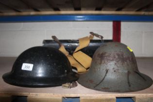 A WWII helmet, a motorcycle messengers tin carrier