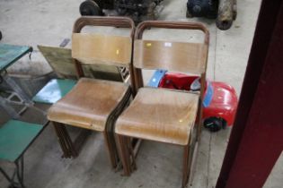 A set of eight wooden and metal stacking chairs