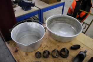 An aluminium jam pan with twin handles and a swing