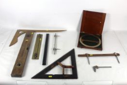A wooden builders level by John Rabone, Vincent Taylor cutter square with brass mounts, a brass