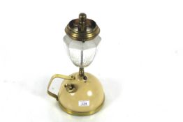 A Tilley table lamp with brass mounts, decorative glass shade and with a short stem and handle
