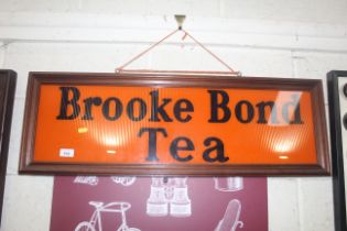 A framed glass sign for "Brook Bond Tea", approx. 34" x 11½"