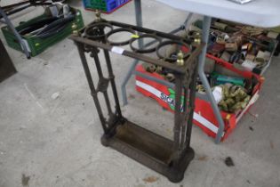An ornate cast iron and brass stick stand