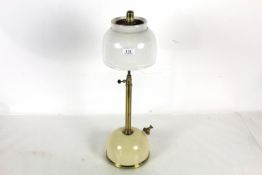 A brass mounted Tilley lamp with long stem and ori