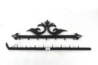 Two early 19th Century metal utensil racks, one pl