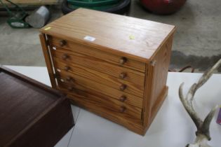 A pine collector's storage cabinet with five drawe