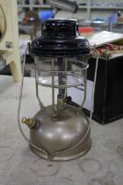 A 1950's storm Tilley lantern with a black top