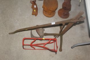 A cast iron cart jack, a shoe last and a saddle ra