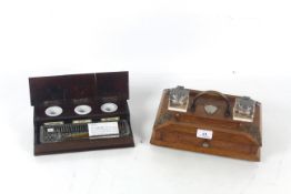 A wooden pen and ink stand with three red, black a