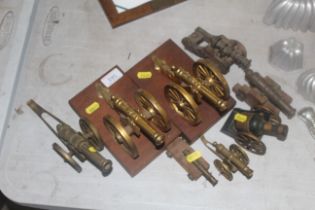 A pair of small brass cannons mounted to wooden plaques and six other various small model cannons