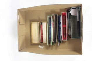 A box containing seven various fountain pens and p