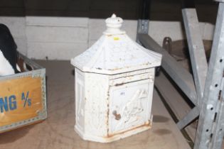 A cast iron pagoda shaped letter box with key