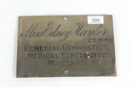 A brass sign for "Miss Edney Hayter CSMMG Remedial