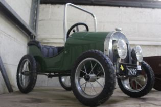 A reproduction vintage child's pedal car