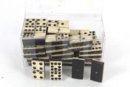 A quantity of Victorian ebony and bone dominoes