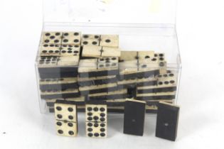 A quantity of Victorian ebony and bone dominoes