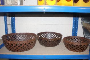 A set of three metal graduated lattice bowls