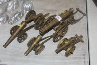 Five brass model cannons