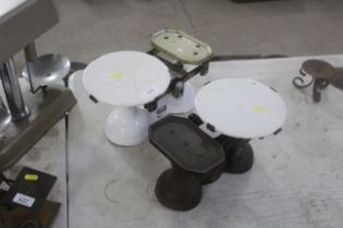 Two sets of balance scales with ceramic plates