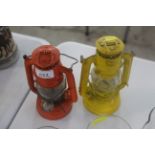 Two small hurricane lamps