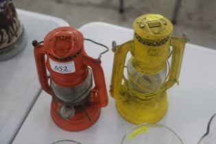 Two small hurricane lamps