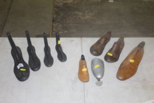 A graduated set of metal shoe lasts, wooden shoe s