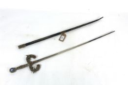 An ornamental sword in scabbard, the hilt set with