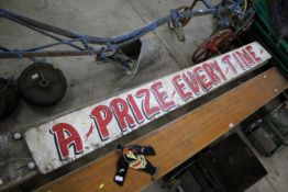 A painted sign "A Prize Every Time" (broken in mid